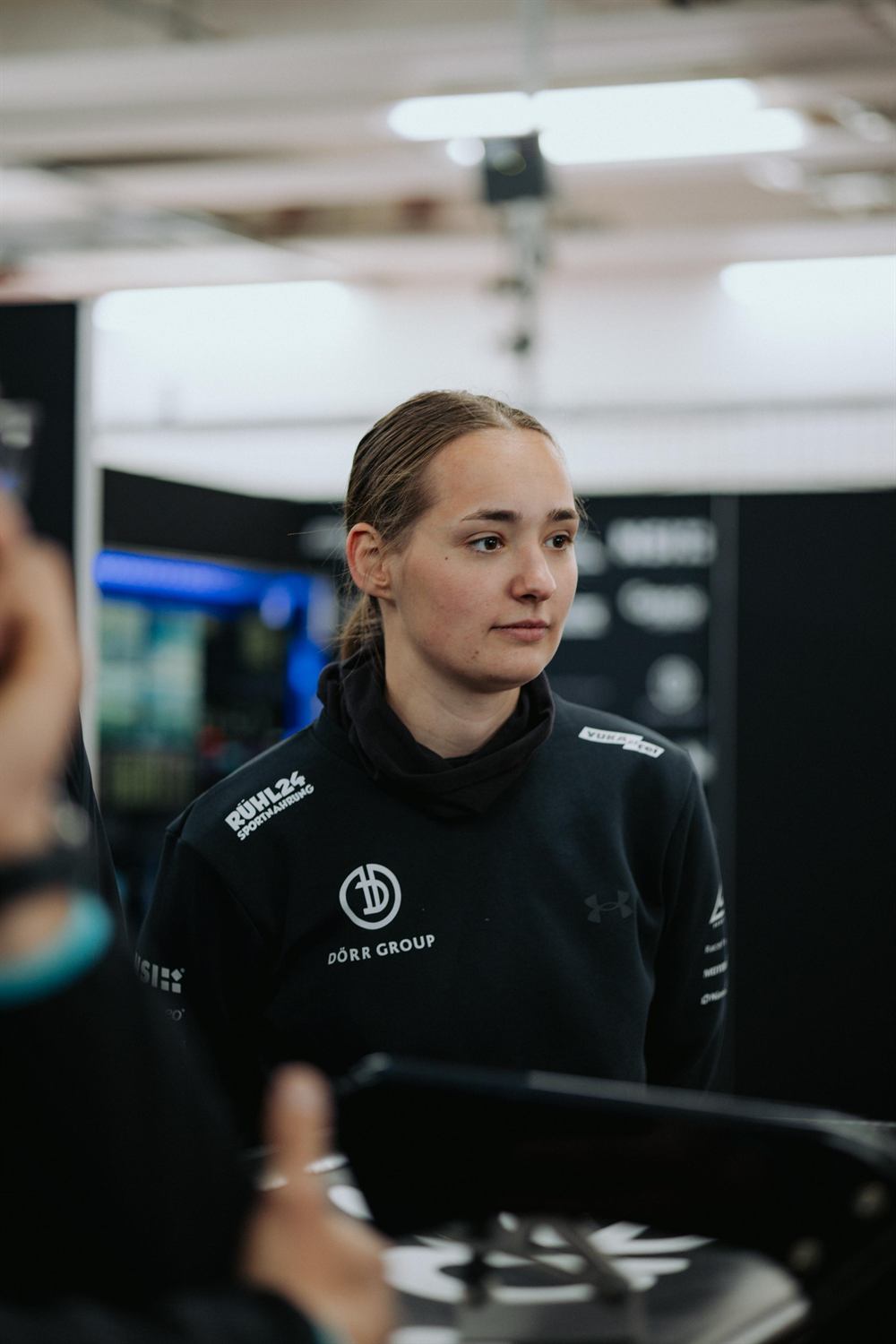 Mandy Paschen in Dörr Group team wear in the pit garage
