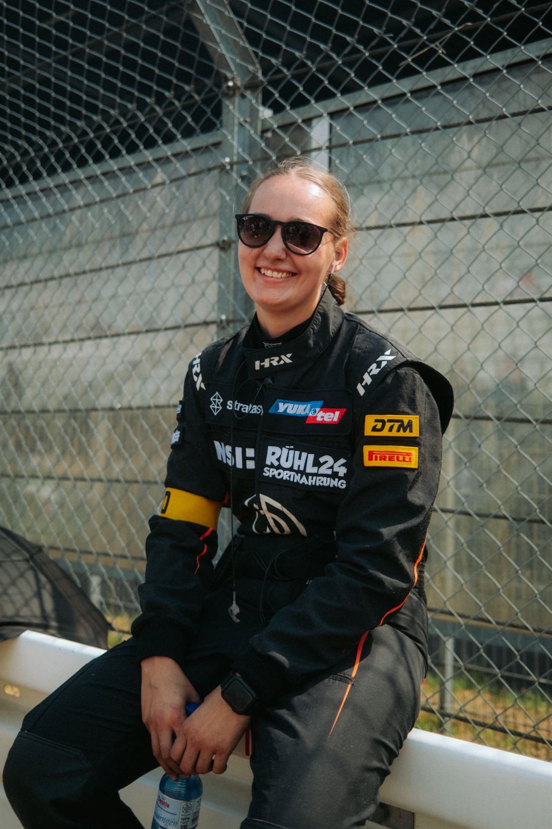 Mandy Paschen, freelance race mechanic, in team gear at the track
