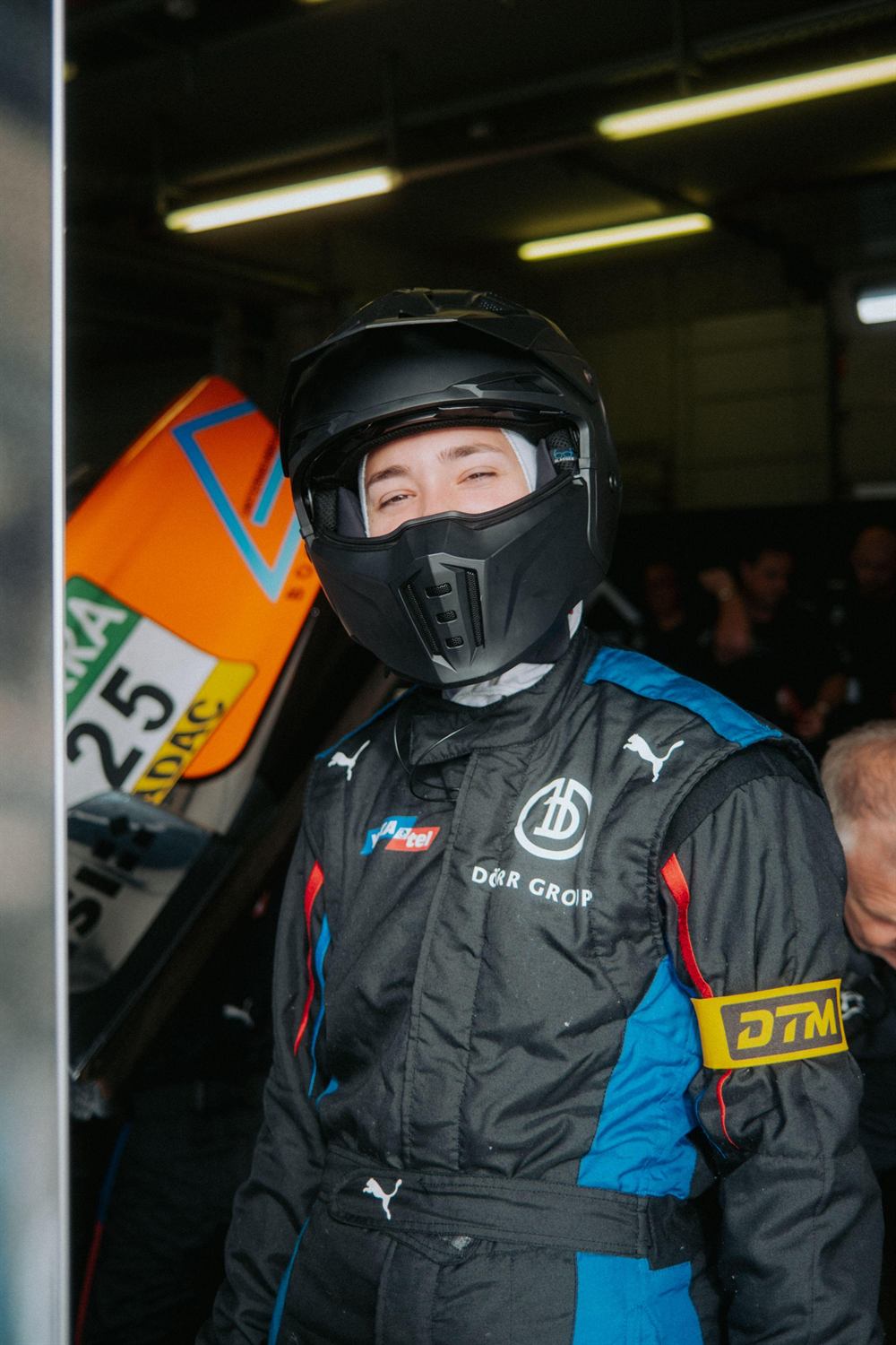 Mandy Paschen with helmet and DTM accreditation in the pit garage