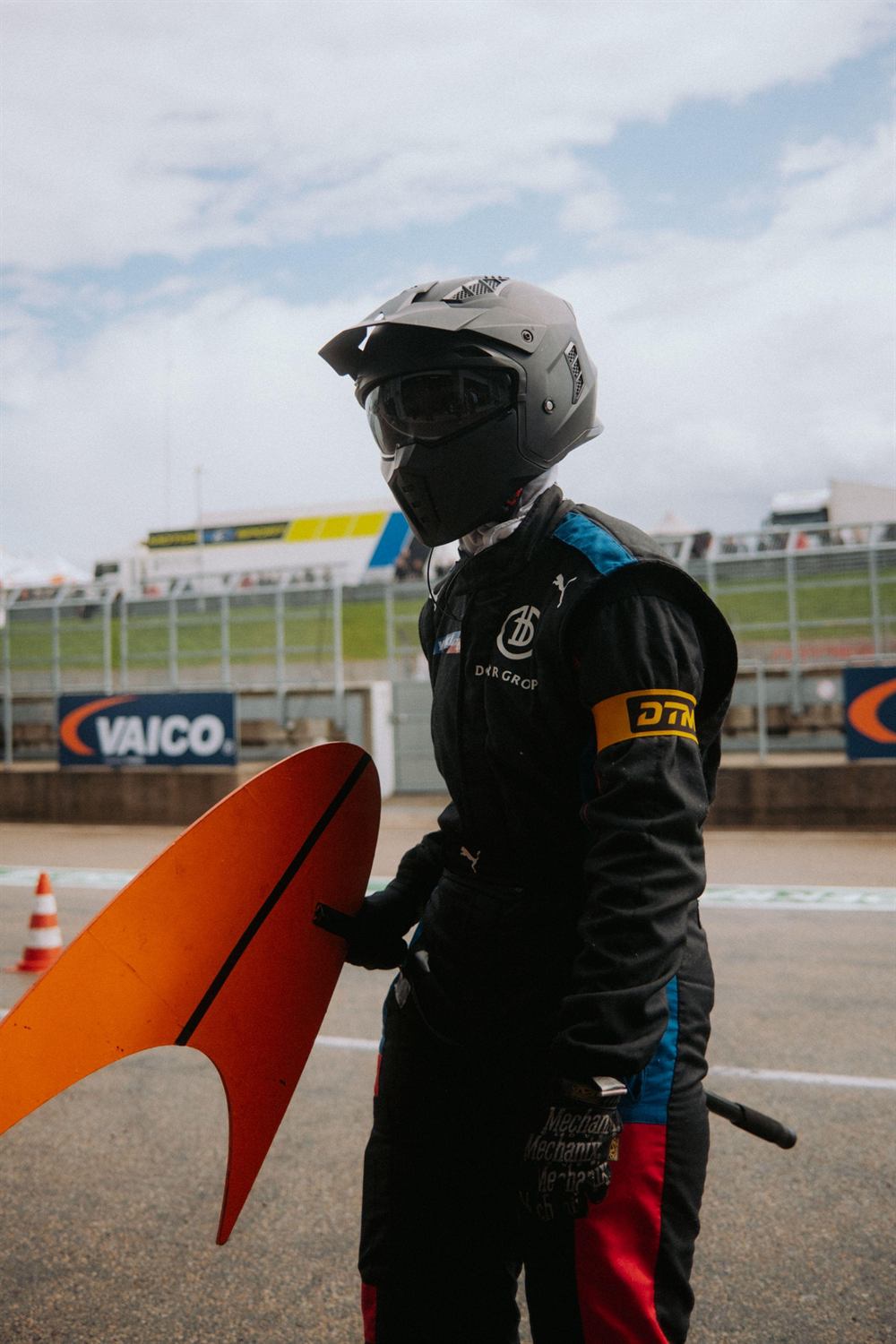 Mandy Paschen with helmet next to the bodywork of the McLaren 720S GT3